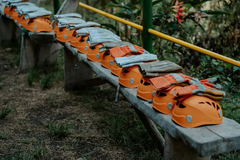 Helmets and leather gloves laid out on a bench before the activity