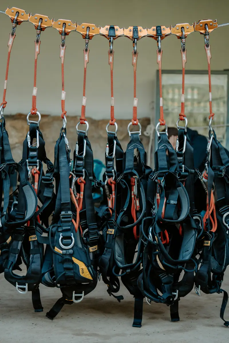 Row of Petzl harnesses and pulleys ready for the day at Machu Picchu Zipline