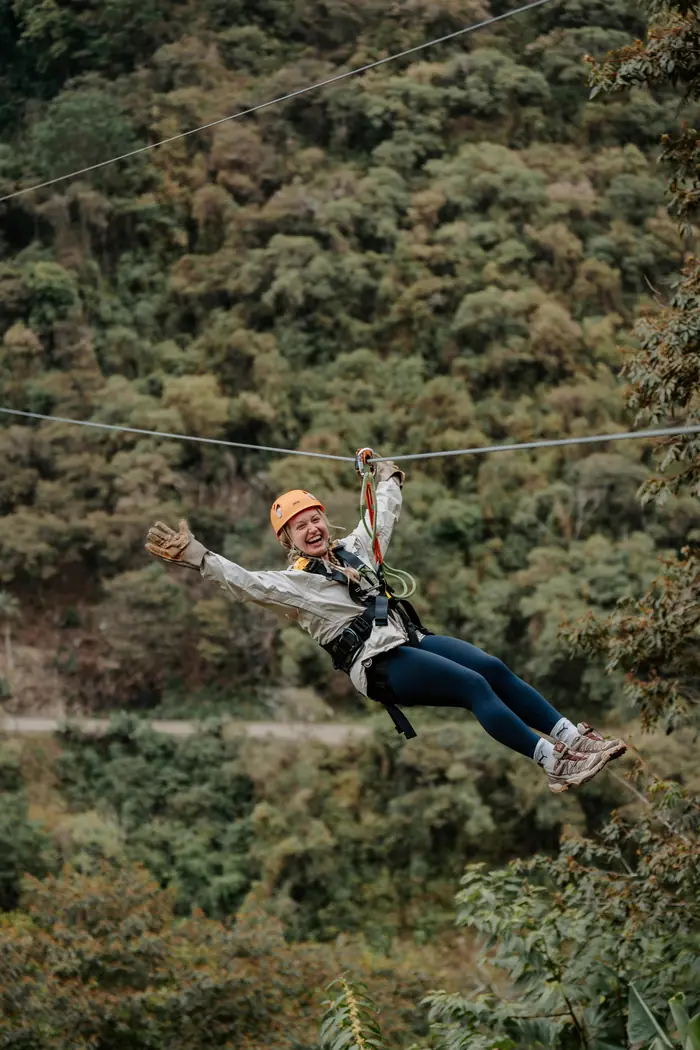 Visitor in helmet and harness ready to start the zipline circuit